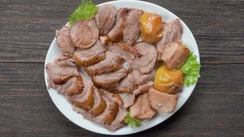 Serving a Plate of Sliced Roasted Duck on the Table Stock Footage 316087282