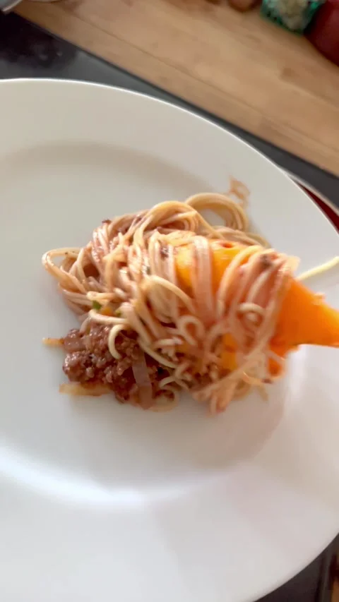 Serving up a plate of spaghetti with meat sauce Stock Footage 250125531