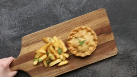 Serving a Plate of Steak and Kidney Pie with Chips Stock Footage 239961522