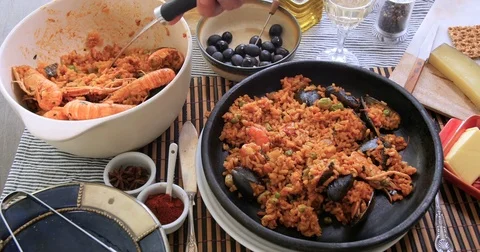 Serving a portion of delicious Spanish seafood paella Stock Footage 73139539