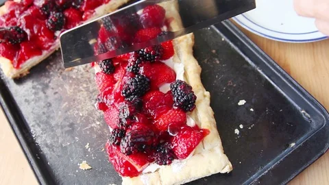 Serving a portion of fresh berry tart Stock Footage 98551949