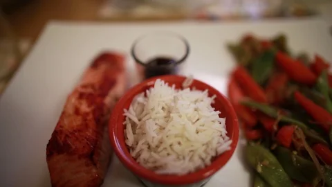 Serving portioned rice, fish, vegetables a on a tray at a Vietnamese restaurant Stock Footage 128949616
