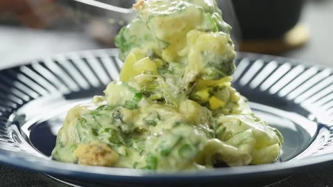 Serving the potatoes and spinach casserole on the plate. Stock Footage 207023160