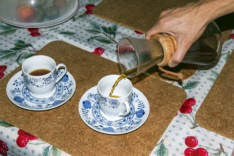 Serving Pour-Over Coffee into Second Blue and White Cup Stock Photos