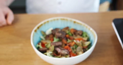 Serving preparing salad with meat, colorful vegetables in plate cooked by chef Stock Footage 132967585