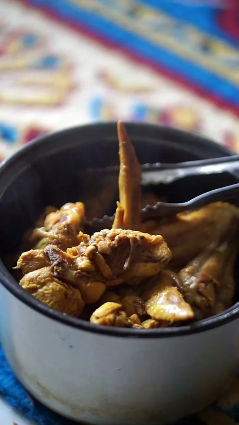 Serving process of boiled chicken wings using tongs, illustrating a simple Stock-Footage 325612686