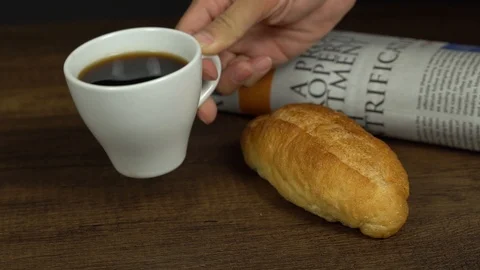 Serving put down coffee cup with coffee beans and bread and newspaper Stock Footage 113003545