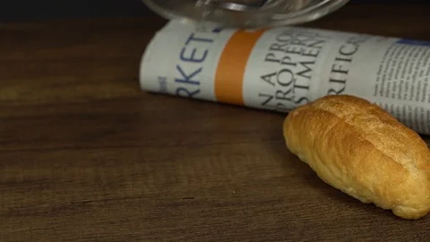 Serving put down coffee glass cup with bread and newspaper Video stock 113003560