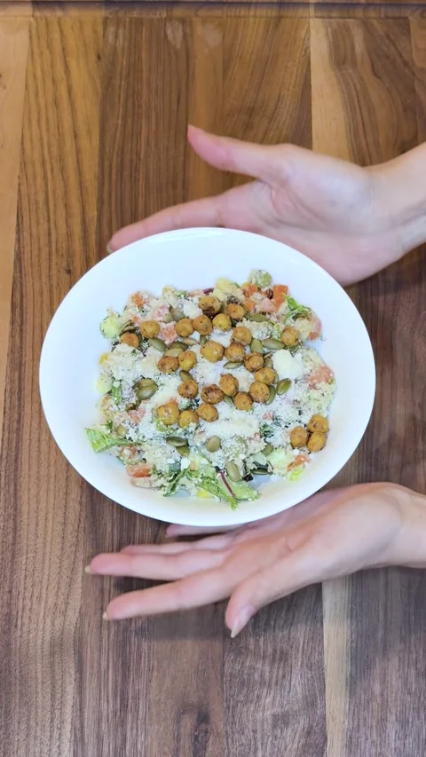 Serving Quinoa Salad with Parmesan, Pumpkin Seeds, and Crispy Chickpeas Stock Footage 333790642