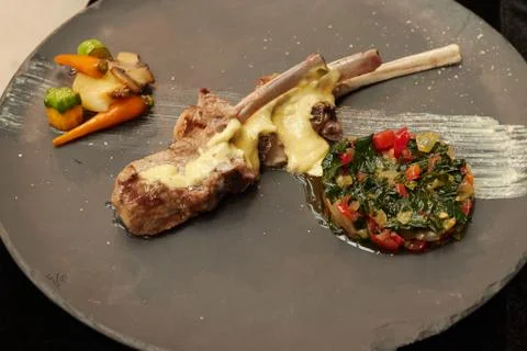 Serving rack of lamb on a plate. vegetable stew.  sauce Stock Photos