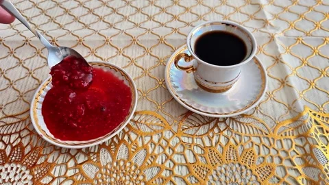 Serving Raspberry Jam Beside a Cup of Black Coffee on Crochet Lace Vidéo 346743584
