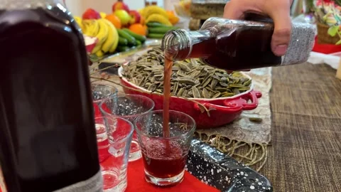 Serving red wine drink and maple syrup cherry pomegranate sorbet Yalda night Stock Footage 338271015