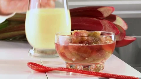 Serving rhubarb compote with custard Stock Footage 8572680