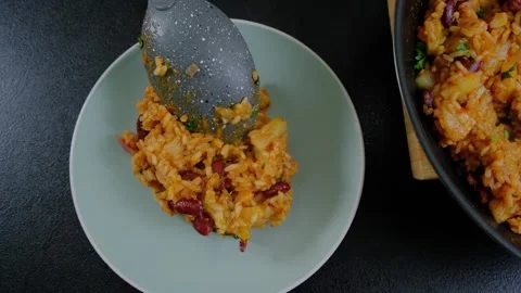 Serving Rice and Beans on Black Countertop in Cooking Scene Stock Footage 341440513