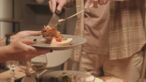 Serving Roast Chicken at a Cozy Dinner with Friends Stock Footage 321985370