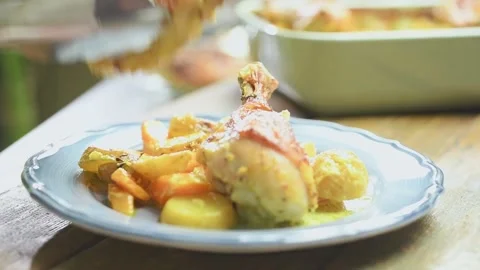 Serving of roasted chicken drumsticks with potatoes and curry. Stock Footage 168146643