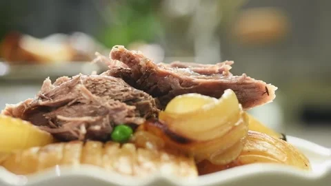 Serving roasted lamb shoulder with vegetables. Stock Footage 195531236