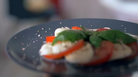 Serving salad Caprese on a black background. Very appetizing Stock Footage 109270021