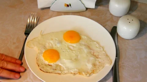 Serving scrambled eggs on a plate, standing on a table with a tablecloth 2 Stock Footage 43571354