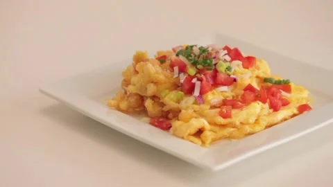 Serving scrambled eggs in a white plate Stock Footage 133815023