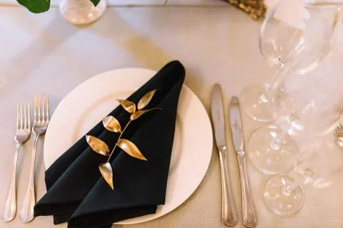 Serving, setting table. Two plates and silverware cutlery, linen napkin are d Stock Photos