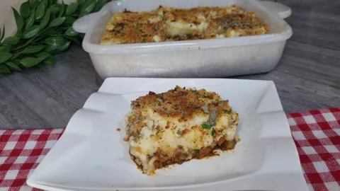 Serving Shepherd's Pie Slice on White Plate with Baking Dish Background 4K Stock Footage 348003726