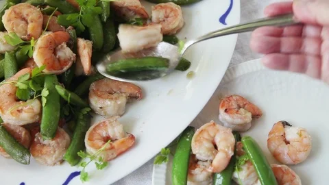 Serving shrimp with snap peas Stock Footage 108794389
