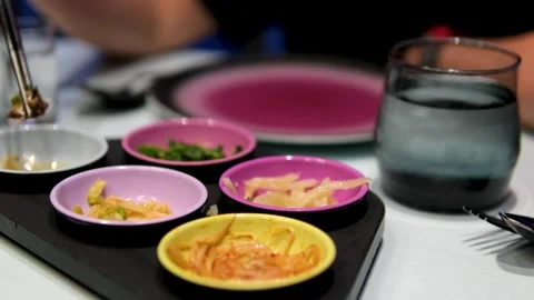 Serving snacks on table korean Preparing grill for cooking meat in a Korean Stock Footage 307742668