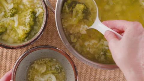 Serving soup. Cauliflower broccoli soup in a bowl close-up on a table Stock Footage 230551186