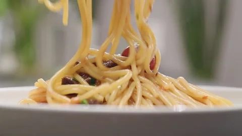 Serving of spaghetti alla Puttanesca on a plate. Stock Footage 154938726
