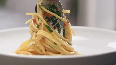 Serving of spaghetti alla Puttanesca on a plate. Video stock 154938730
