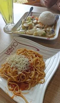 A serving of spaghetti with cheese and cap cay rice, a typical Chinese Stock Photos