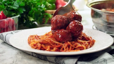 Serving spaghetti with meatballs in tomato sauce Stock Footage 98484435