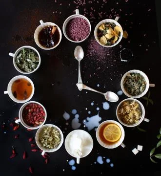 Serving spices in the shape of a wall clock on a black background Stock Photos