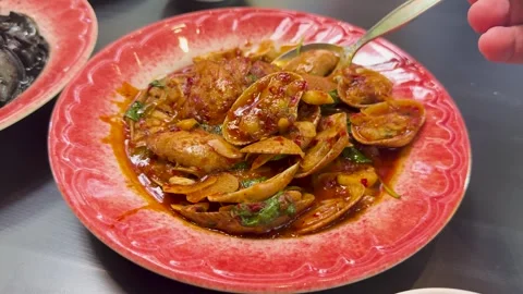 Serving Spicy Clams with Chilli Paste in Red Bowl Stock Footage 314029453