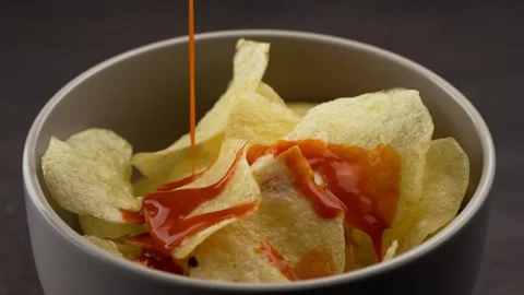 Serving spicy red sauce over home french fries slow motion Stock Footage 280089890