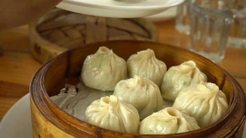 Serving steamed dumplings with fork Stock Footage 149397899