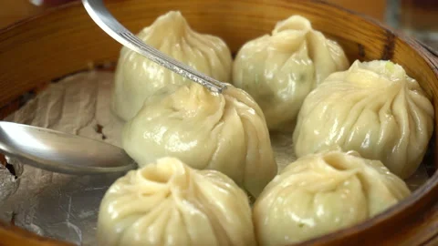 Serving steamed dumplings with fork Stock Footage 149397907