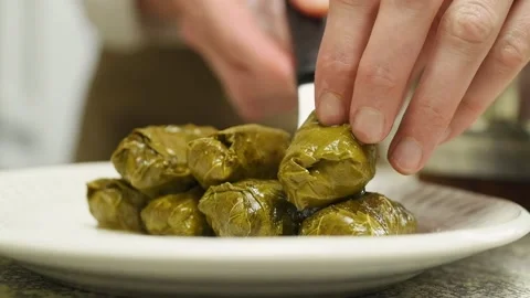 Serving stuffed grape leaves - Dolmas. Stock Footage 207020649
