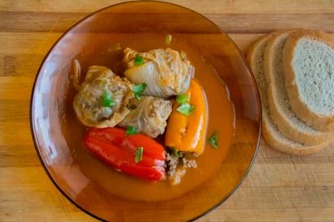 Serving stuffed peppers and cabbage leaves. Stock Photos