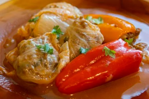 Serving stuffed peppers and cabbage leaves. A typical Balkan dish. Stock Photos