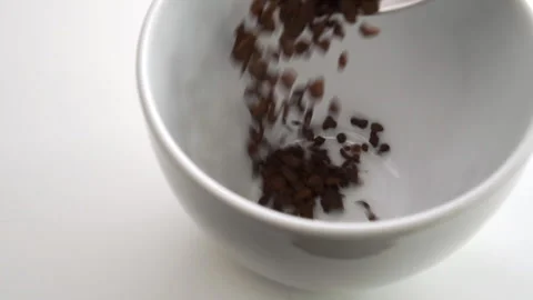 A serving of sublimated instant dried chicory root is poured from a teaspoon  Stock Footage 152140938