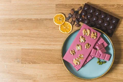 Serving suggestion concept. Bars of premium ruby aand dark chocolate arrenged on 写真素材