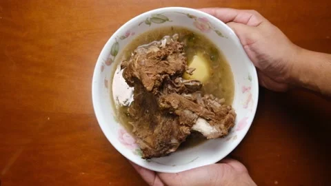 Serving sup tulang Stock Footage 157623955