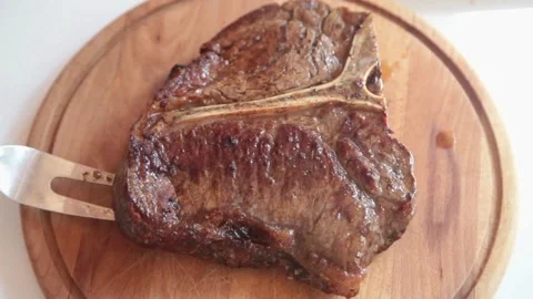 Serving a T- bone Steak Stock Footage 199691496