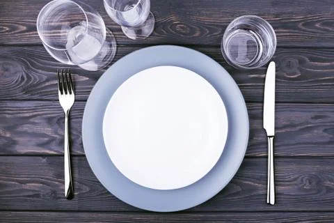 Serving table with empty plate. Stock Photos