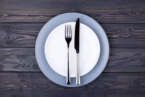 Serving table with empty plate. Stock Photos