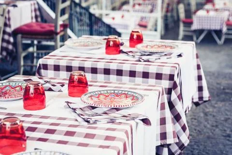 Serving on the table in the restaurant in Catania, Sicily, Italy: plates, gla Stock Photos