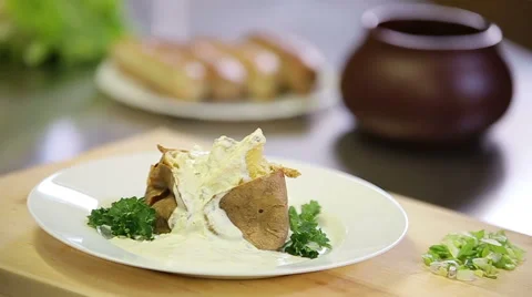 Serving tar tar sauce to baked hot potato dish in jacket Stock Footage 61154278
