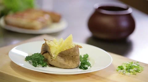Serving tar tar sauce to baked hot potato dish in jacket Stock Footage 68093130